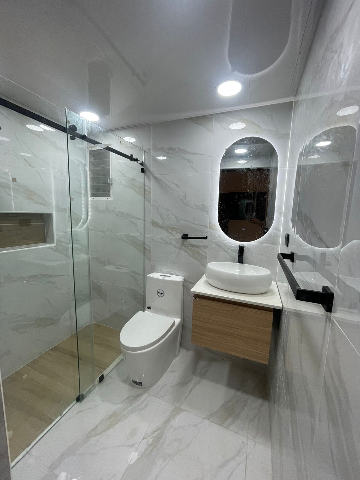Baño en mármol calacatta con ducha en madera